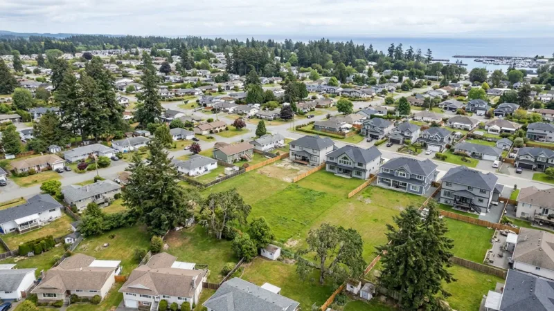 Aerial view of a Vancouver Island residential neighbourhood showing single-family lots with development potential near the waterfront