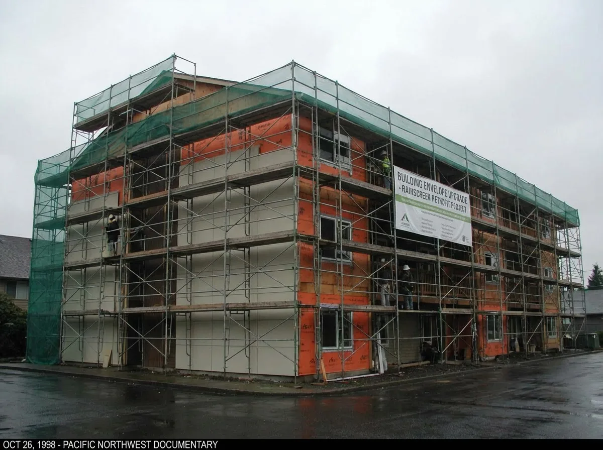 1990s condominium building undergoing rainscreen retrofit with scaffolding